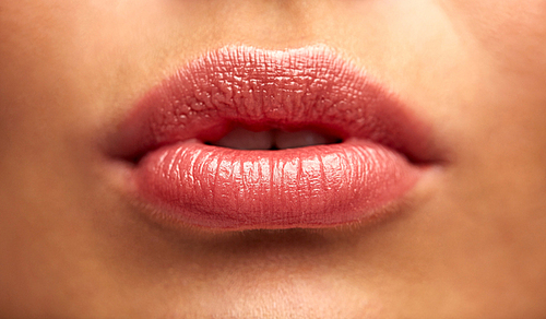 beauty, people, make-up, plastic surgery and cosmetics concept - close up of young woman lips