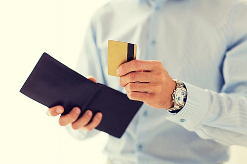 people, business, finances and money concept - close up of businessman hands holding open holding wallet and credit card