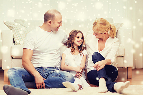 family, childhood, communication, people and home concept - smiling parents with little girl sitting on floor at home