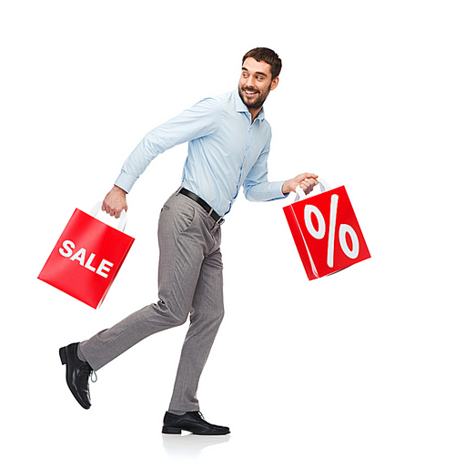 people, sale, discount and holidays concept - smiling man walking with red shopping bags