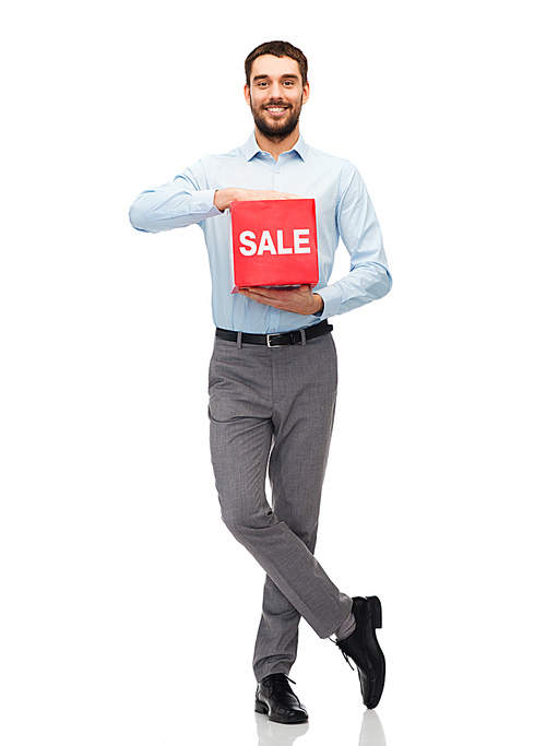 people, shopping, discount and holidays concept - smiling man holding red sale sign
