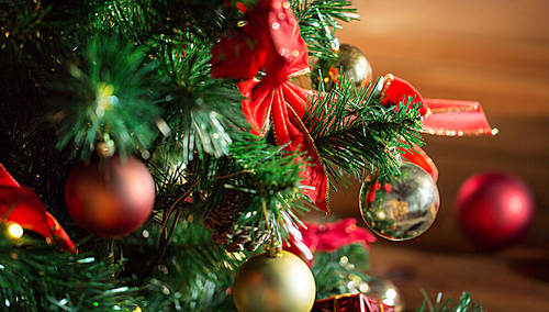 holidays, new year and celebration concept - close up of christmas tree decorated with balls