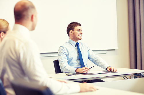 business, people and teamwork concept - group of smiling businesspeople meeting in office