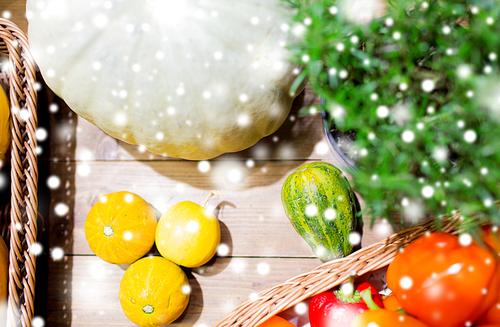 sale, farming, agriculture and  food concept - ripe vegetables in baskets on table at grocery market or farm over snow effect