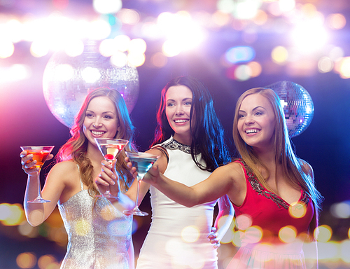 holidays, nightlife, bachelorette party and people concept - smiling women with cocktails at night club