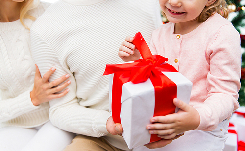 holidays, winter and christmas concept - close up of family with child holding gift box at home