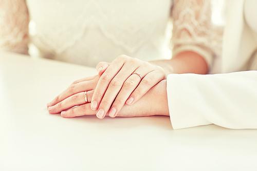 people, homosexuality, same-sex marriage and love concept - close up of happy married lesbian couple hugging