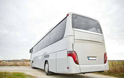 travel, tourism, road trip and passenger transport - tour bus driving outdoors from back