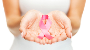 healthcare and medicine concept - womans hands holding pink breast cancer awareness ribbon
