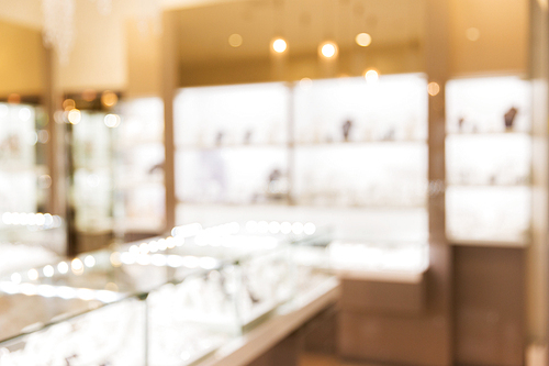 sale, consumerism, shopping and background concept - jewelry store blurred bokeh