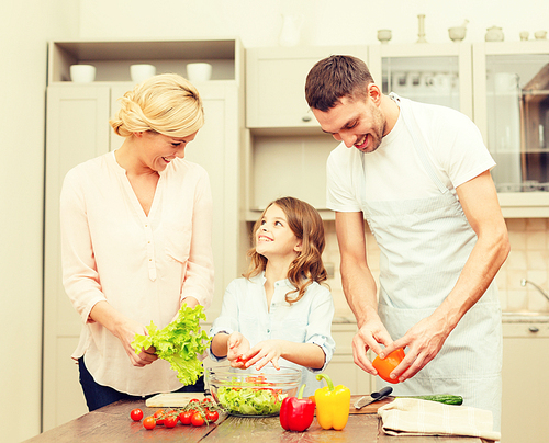 food, family, hapiness and people concept - happy family making dinner in kitchen