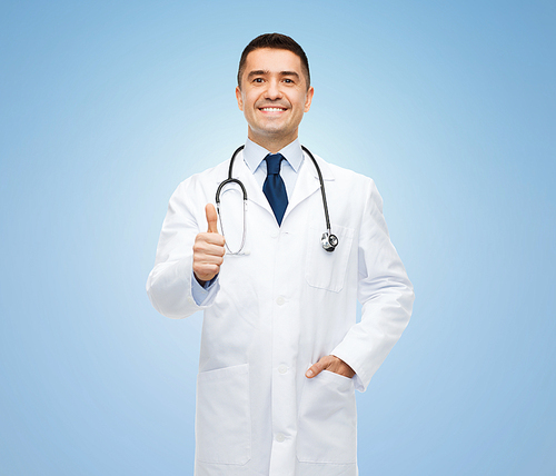 healthcare, profession, people and medicine concept - smiling male doctor in white coat with stethoscope showing thumbs up over blue background