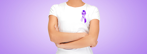 charity, people, health care and social issue concept - close up of woman with purple domestic violence awareness ribbon on her chest over violet background