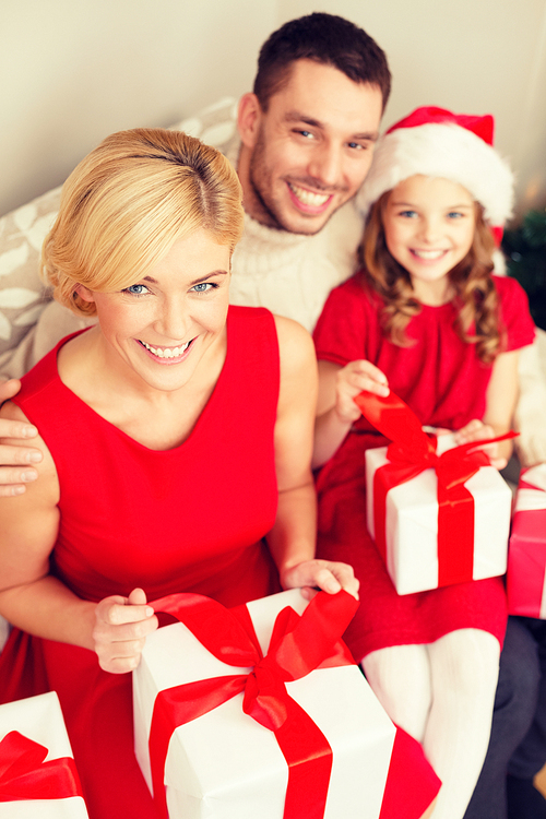 family, christmas, x-mas, winter, happiness and people concept - happy family opening gift boxes