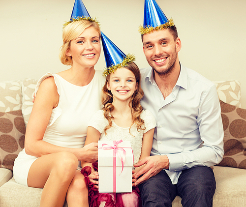 celebration, family, holidays and birthday concept - happy family with gift box