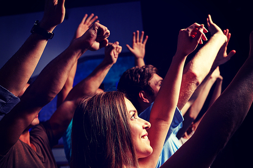 party, holidays, celebration, nightlife and people concept - smiling friends waving hands at concert in club