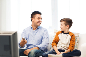 family, people, technology, television and entertainment concept - happy father and son with remote control watching tv at home