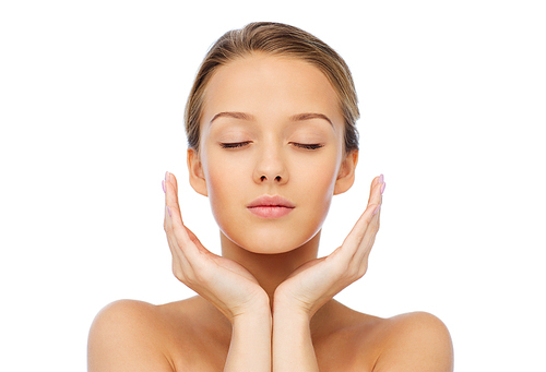 beauty, people, skincare and health concept - young woman face and hands