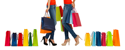people, sale and consumerism concept - close up of women with shopping bags