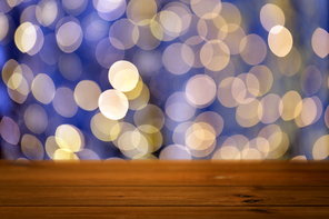 holidays, new year and celebration concept - close up of empty wooden surface or table over christmas golden and blue lights background