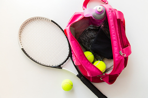 sport, fitness, healthy lifestyle and objects concept - close up of tennis racket and balls with female sports bag