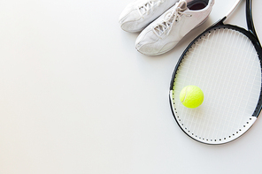sport, fitness, healthy lifestyle and objects concept - close up of tennis racket with ball and sneakers