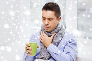 health care, people, winter and medicine concept - ill man with flu coughing and drinking hot tea from cup at home over snow effect