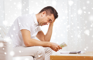 business, savings, financial crisis and people concept - man with money and calculator at home over snow effect