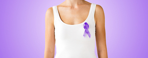 charity, people, health care and social issue concept - close up of woman with purple domestic violence awareness ribbon on her chest over violet background