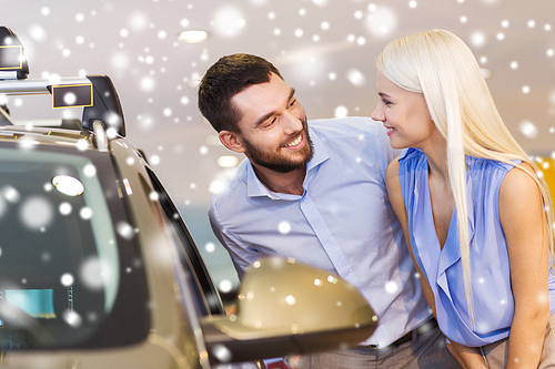 auto business, car sale, consumerism and people concept - happy couple buying car in auto show or salon over snow effect