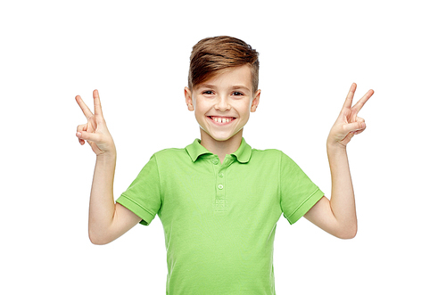 gesture, triumph, childhood, fashion and people concept - happy smiling boy in green polo t-shirt showing peace or victory hand sign