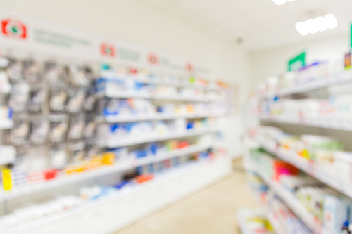 medicine, pharmacy, health care and pharmacology concept - pharmacy or drugstore room blurred background