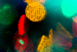 holidays, illumination and electricity concept - colorful bright night lights bokeh over dark background