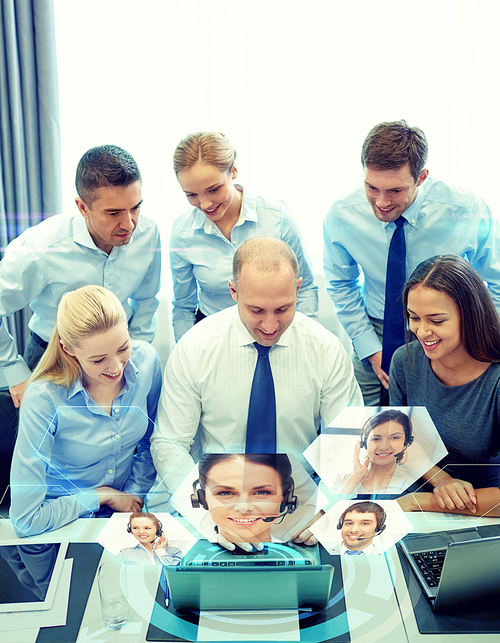 business, people, technology and teamwork concept - smiling business team with laptop computer and virtual projection working in office