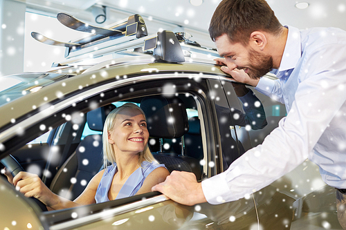 auto business, car sale, consumerism and people concept - happy couple buying car in auto show or salon over snow effect