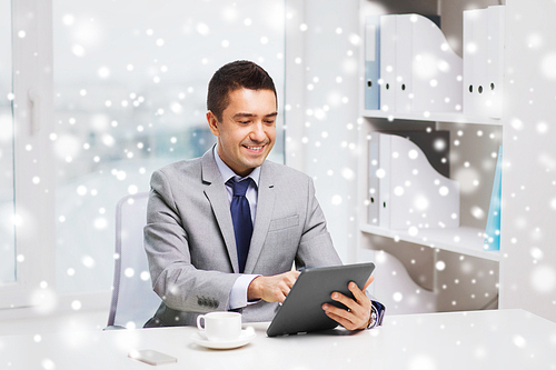 business, education, people and technology concept - smiling businessman with tablet pc computer and coffee in office over snow effect
