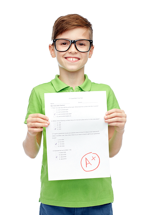 childhood, school, education and people concept - happy smiling boy in eyeglasses holding paper with test result