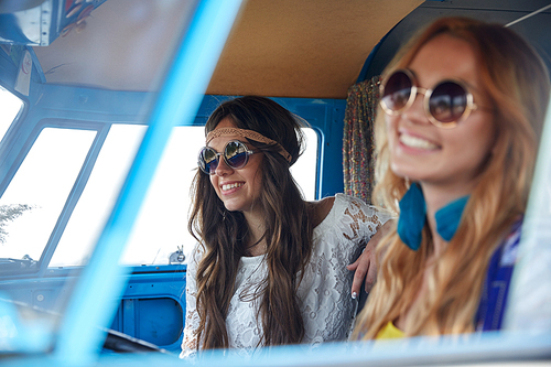 summer holidays, road trip, vacation, travel and people concept - smiling young hippie women driving in minivan car