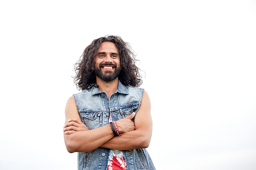 subculture, youth culture and people concept - smiling young hippie man in demin vest