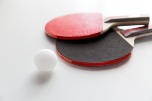 sport, fitness, healthy lifestyle and objects concept - close up of ping-pong or table tennis rackets with ball