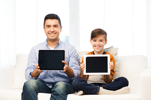 leisure, technology, technology, family and people concept - happy father and son with tablet pc computer networking or playing at home