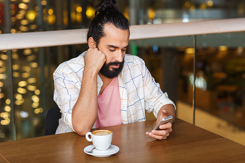 leisure, technology, lifestyle and people concept - man with smartphone and coffee at restaurant