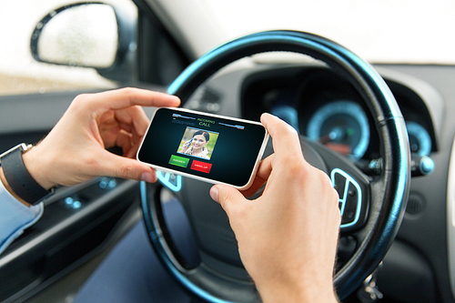 transport, business trip, communication, technology and people concept - close up of male hands with incoming video call icon on smartphone screen in car