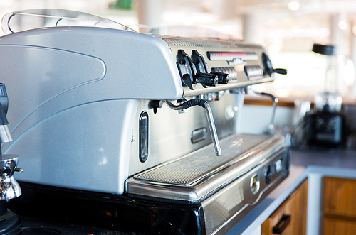 equipment, object and technology concept - close up of coffee machine at bar or restaurant kitchen