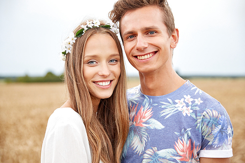 summer holidays, love, romance and people concept - happy smiling young hippie couple hugging outdoors