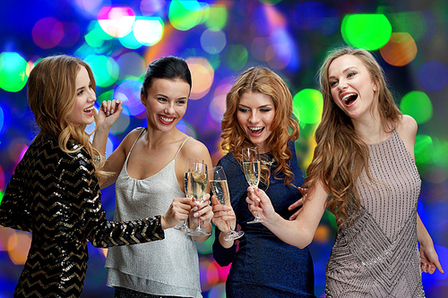 celebration, friends, bachelorette party and holidays concept - happy women clinking champagne glasses and dancing over lights background