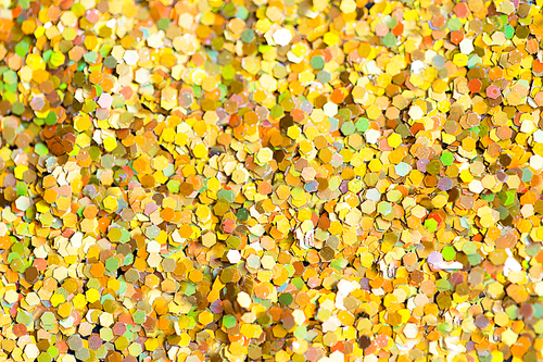 holidays, decoration and texture concept - golden glitter or yellow sequins background