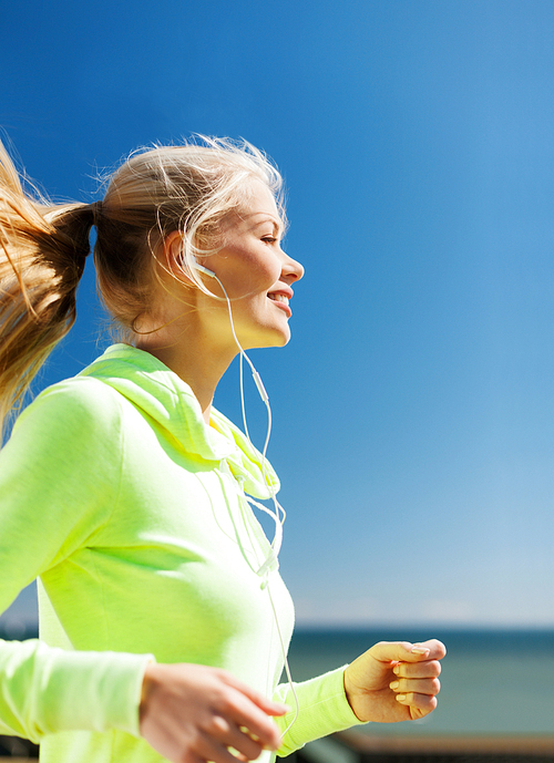 sport and lifestyle concept - woman doing running outdoors