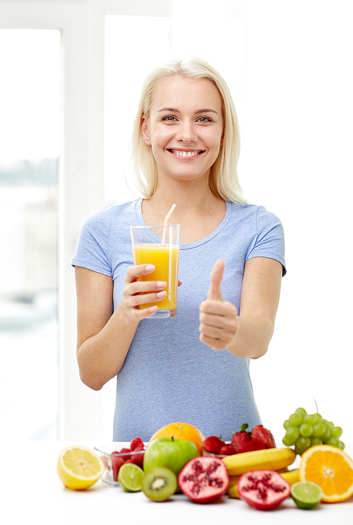 healthy eating, vegetarian food, dieting and people concept - smiling woman drinking fruit shake from glass at home showing thumbs up