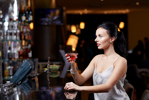 people, party, nightlife, drink and holidays concept - glamorous woman with cocktail at night club or bar